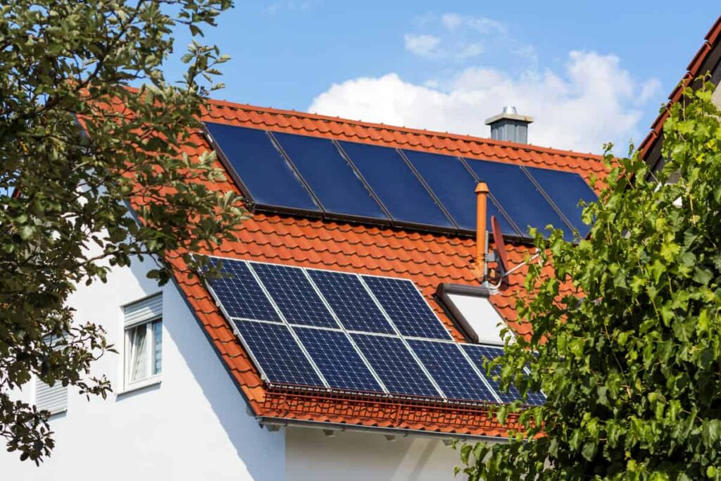 Toiture de maison avec à la fois des panneaux solaires photovoltaïques et thermiques