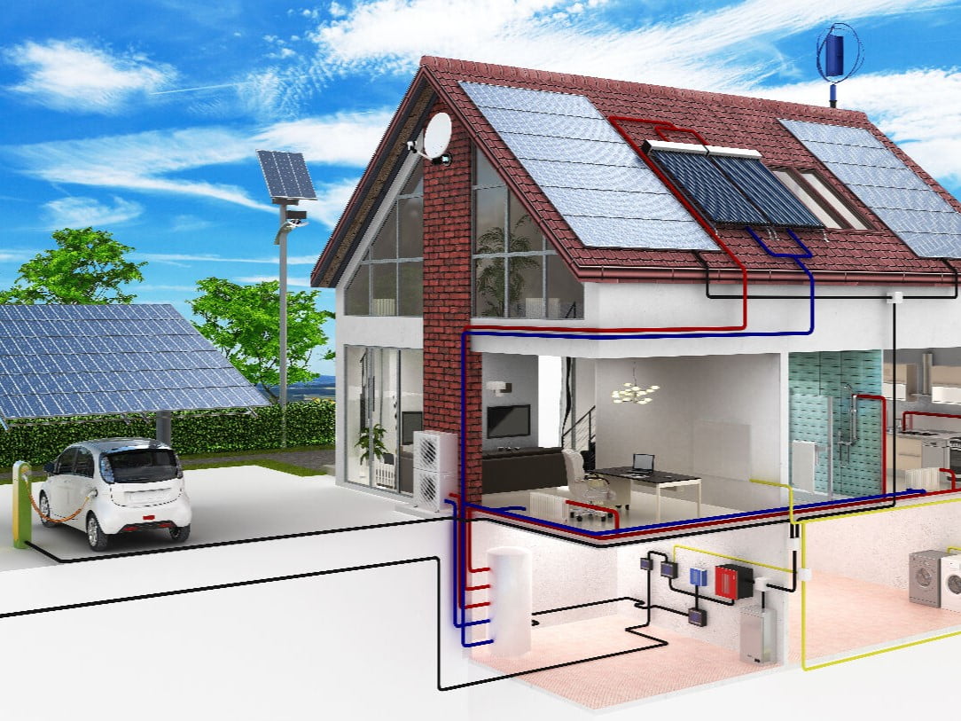 Schéma illustrant le fonctionnement d’une maison passive équipée de panneaux solaires, de batteries, d’une borne de recharge pour véhicule électrique et de systèmes thermiques intégrés.
